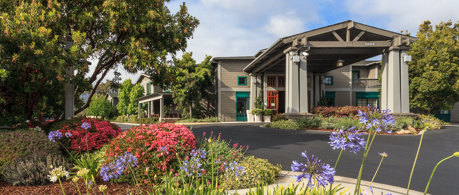 Image showcasing the front of the Carpinteria Express Hotel along with plant life next to the building