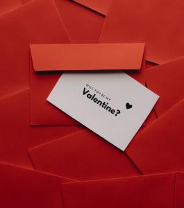 "Will you be my Valentine?" invitation on a red background