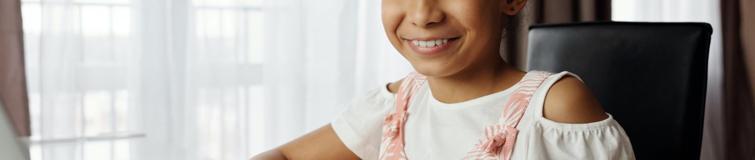 Girl at laptop smiling