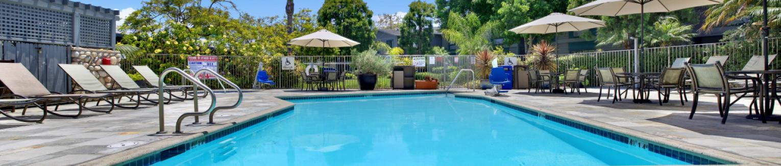 Inviting Pool Deck offering tables, chairs, and chaise lounges
