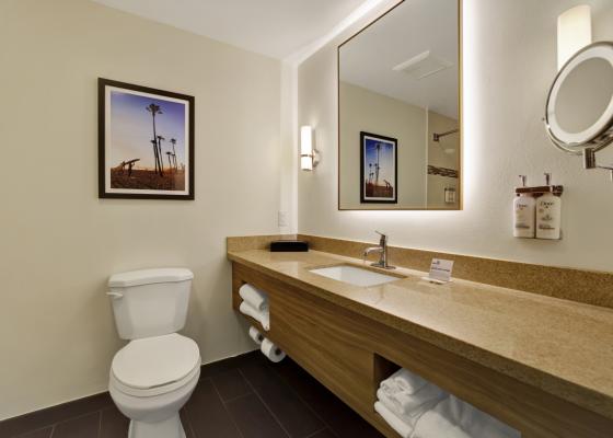 Guestroom baths offer oversized countertops and lighted makeup mirrors